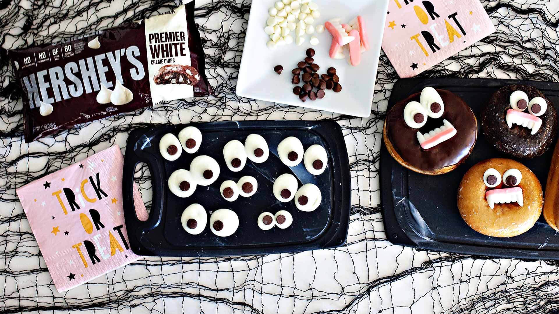 halloween themed donuts decorated with eyes made from hersheys baking chips 