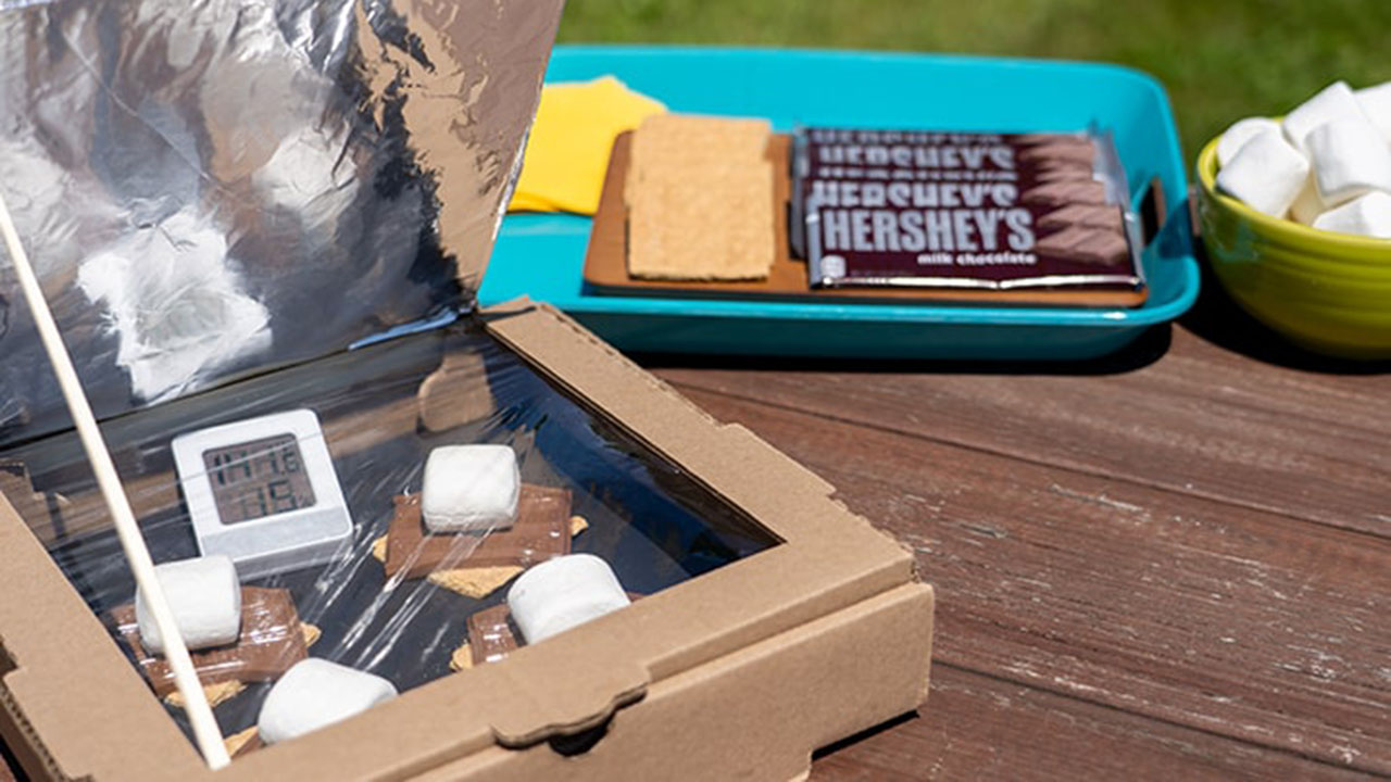 cooking smores outdoors using the smores solar oven