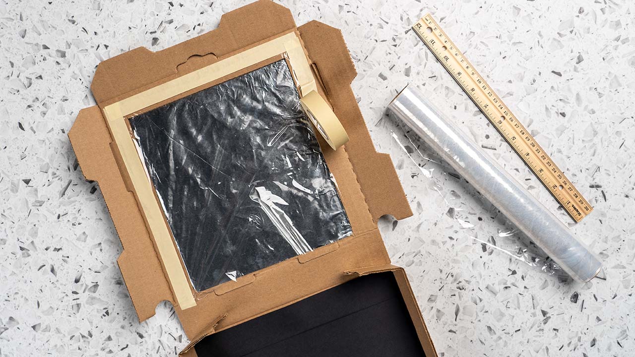 insulating the cardboard box with plastic wrap