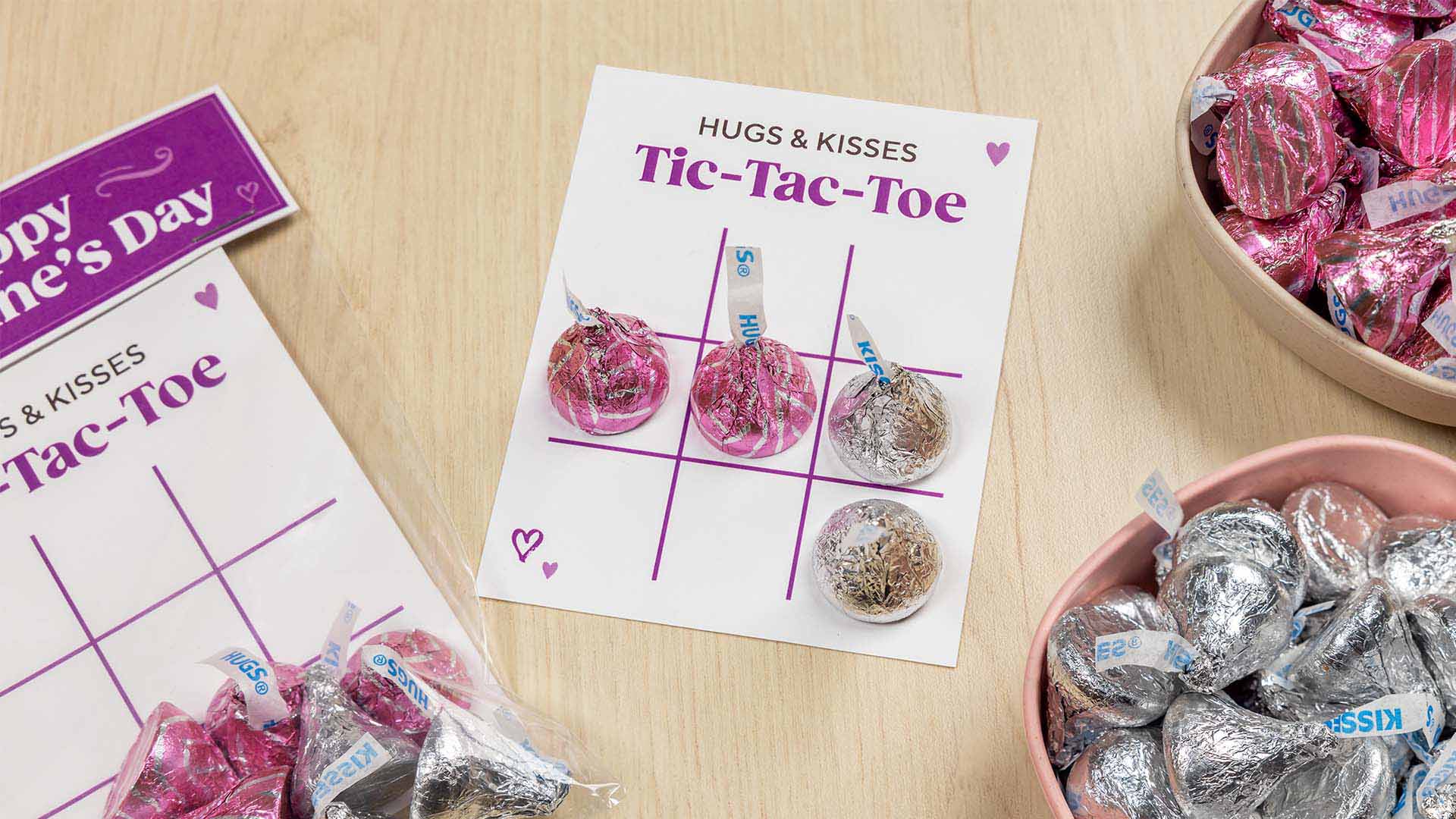 hugs and kisses tic tac toe boards beside bowls of hersheys candy