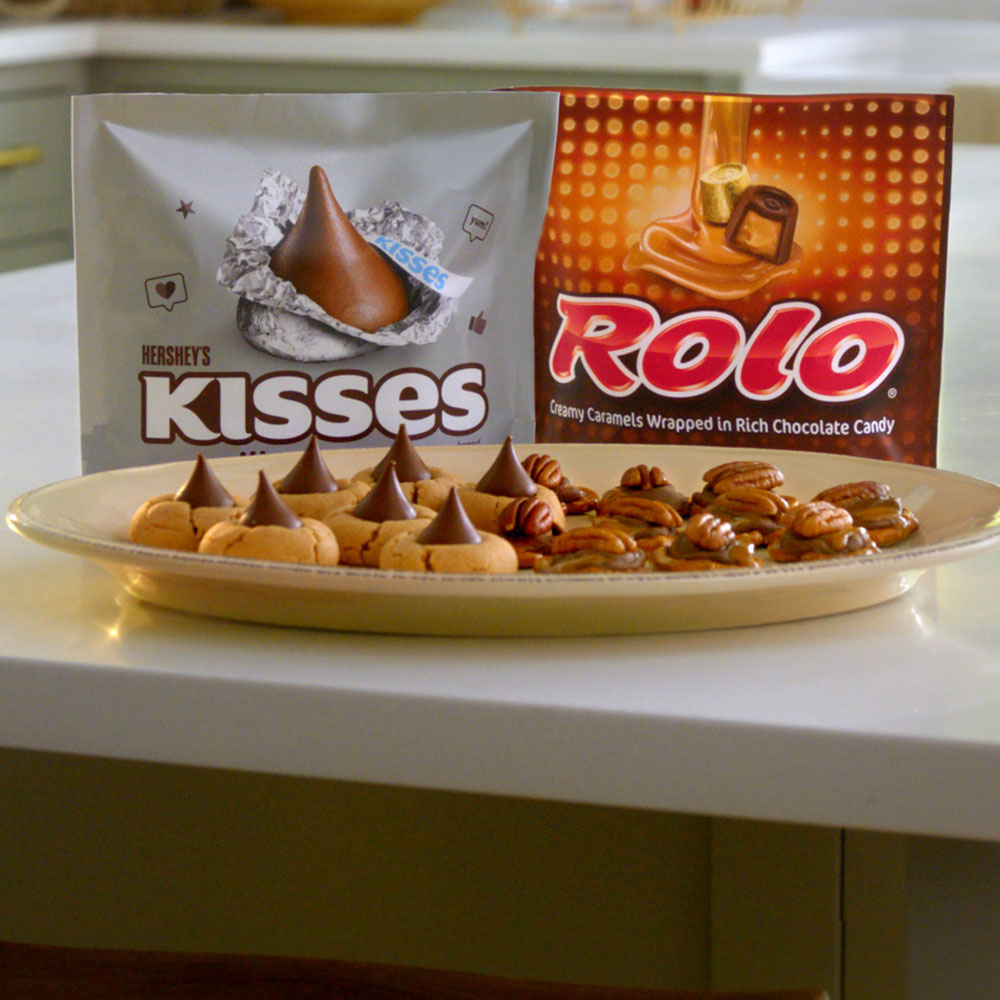 plate of hersheys kisses blossom cookies and rolo pretzel delights