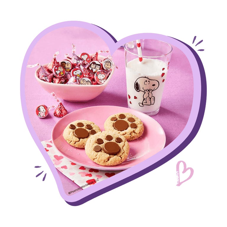 plate of pawprint cookies by bowl snoopy hersheys kisses