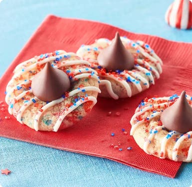 blossom cookies with HERSHEY'S KISSES Candy and red and blue sprinkles