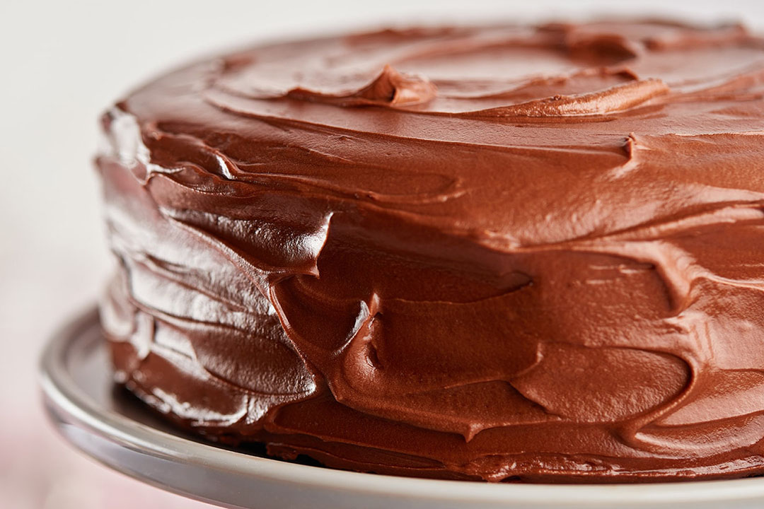 freshly made hersheys perfectly chocolate chocolate cake resting on a cake dish