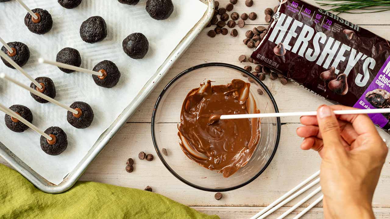 adding lollipop stick to brownie balls