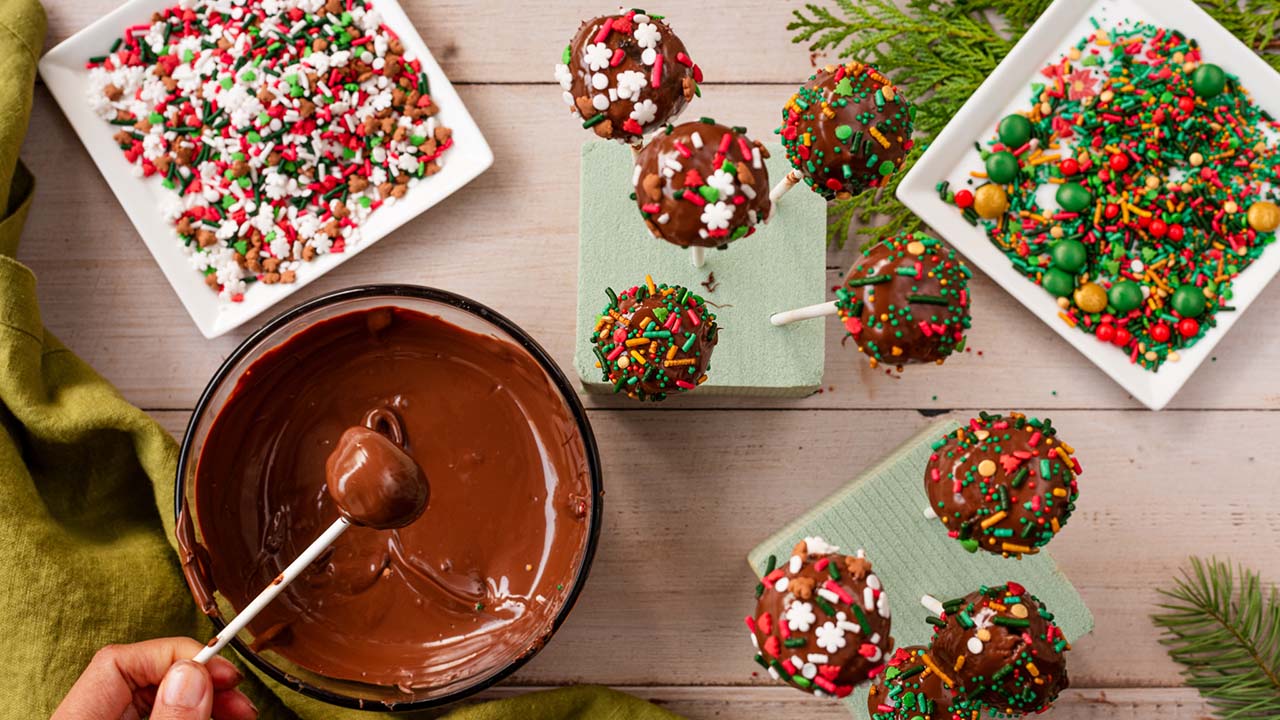 dip brownie pops into melted chocolate