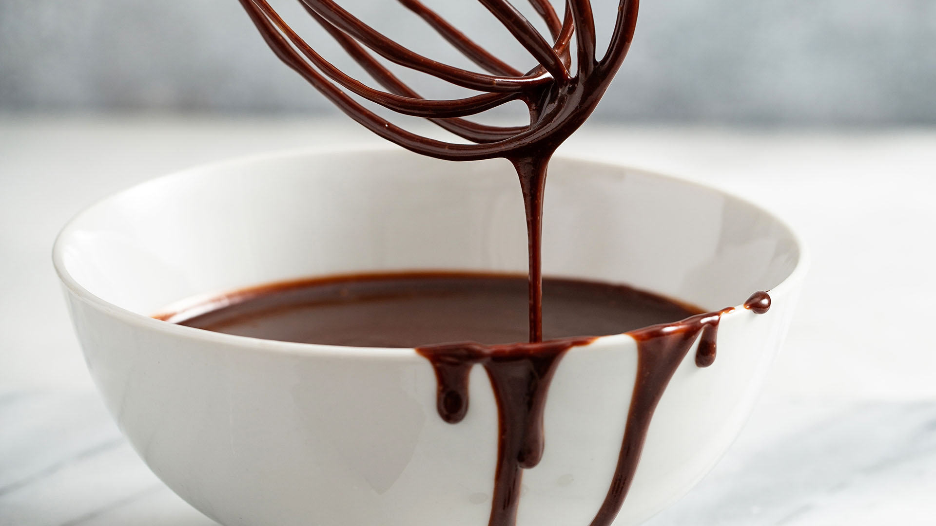 mixing bowl and whisk full of hersheys quick cocoa glaze