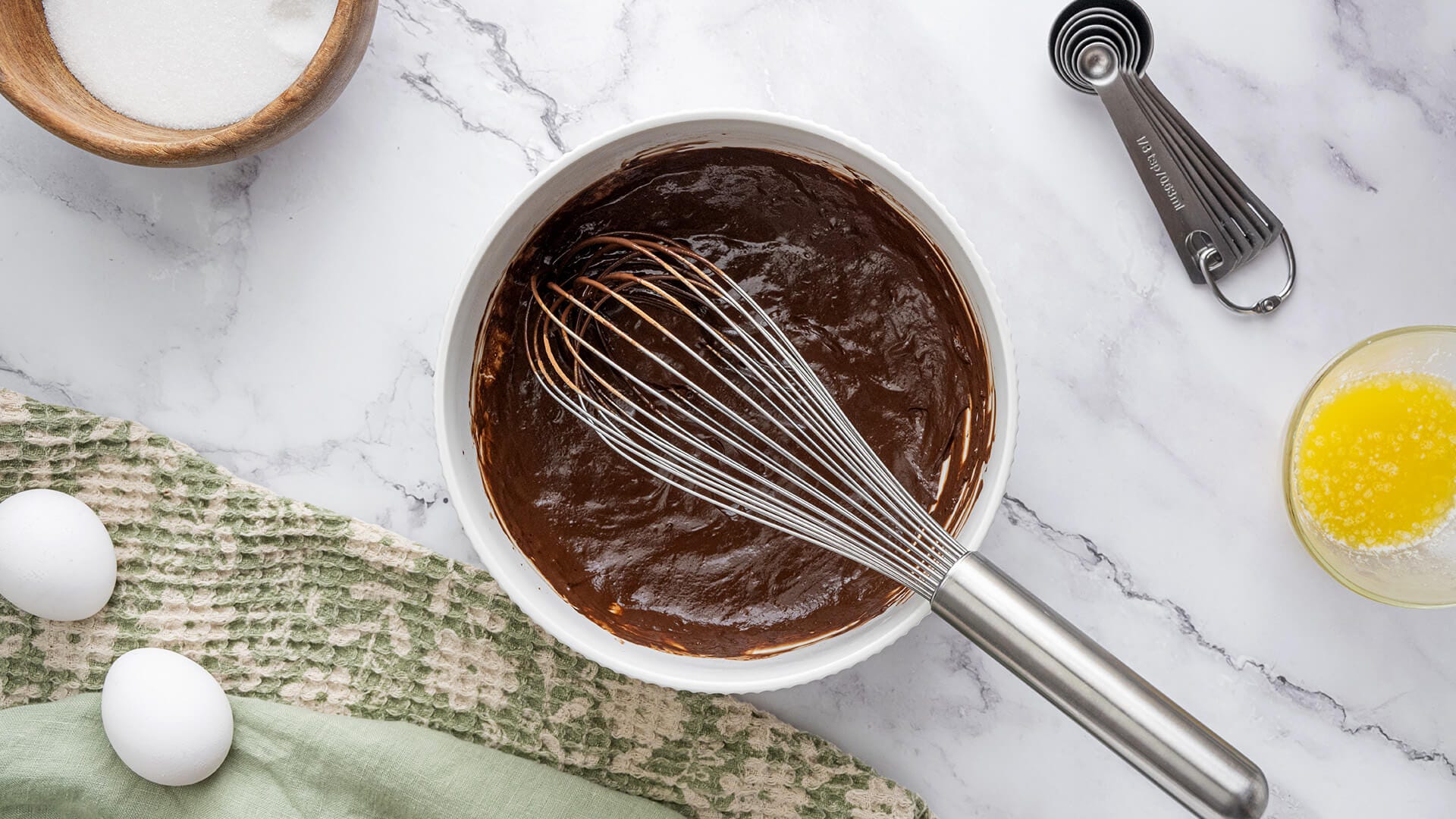 fudge batter in a white bowl with a whisk