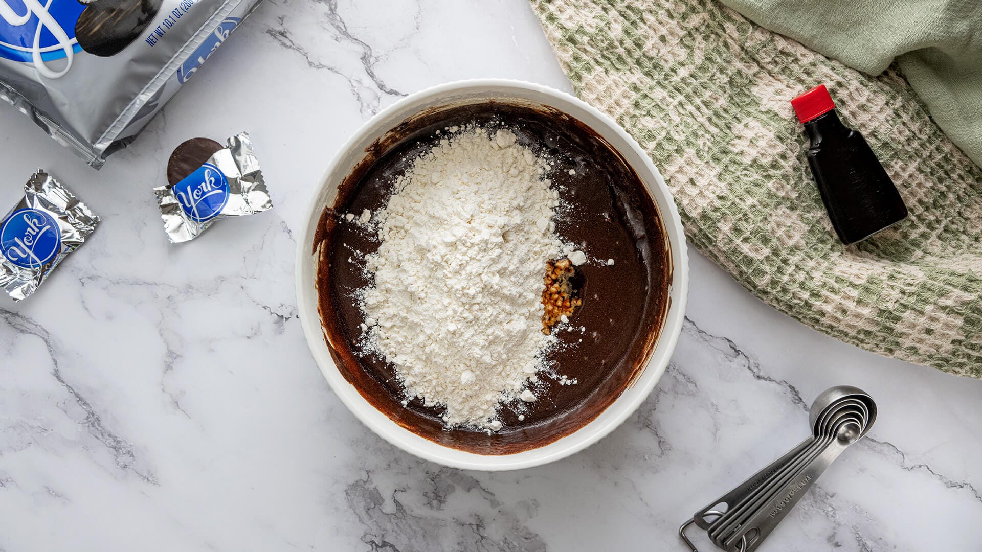 adding flour to fudge batter