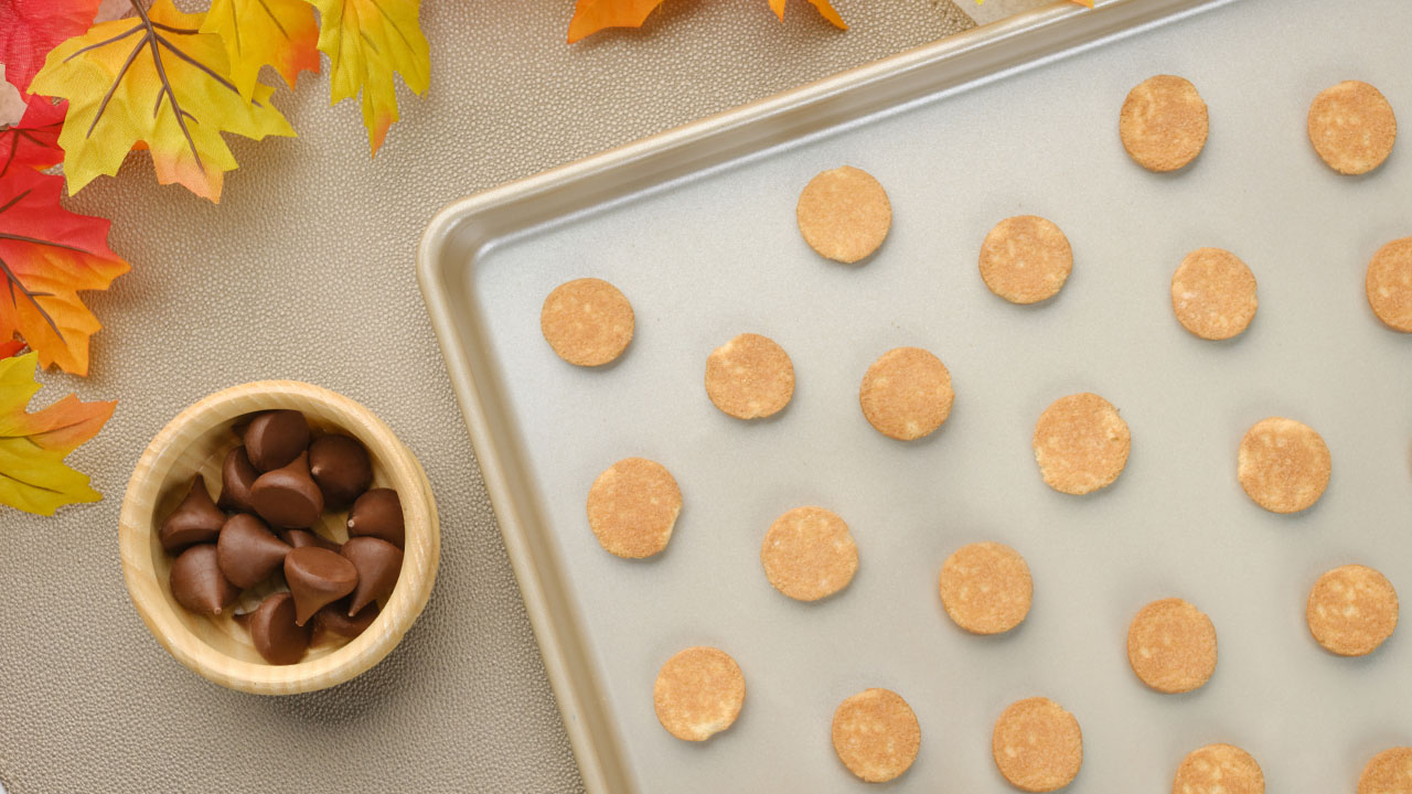 tray topped with vanilla wafer cookies beside bowl of hersheys kisses milk chocolates