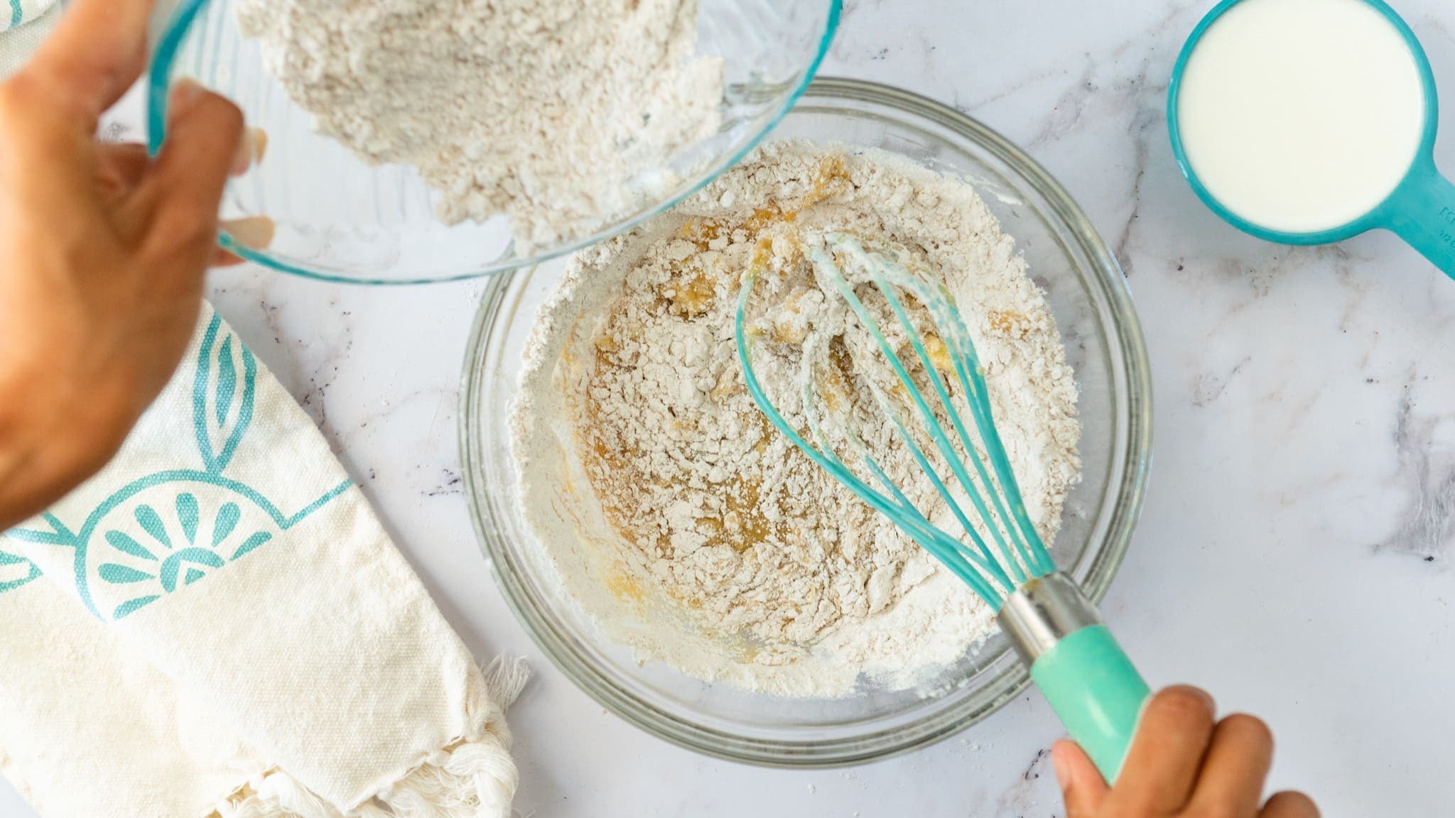 wet ingredients being mixed with dry ingredients