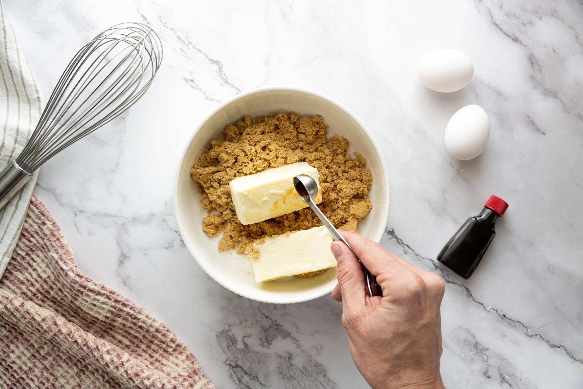 vanilla being added to bowl of dry ingredients