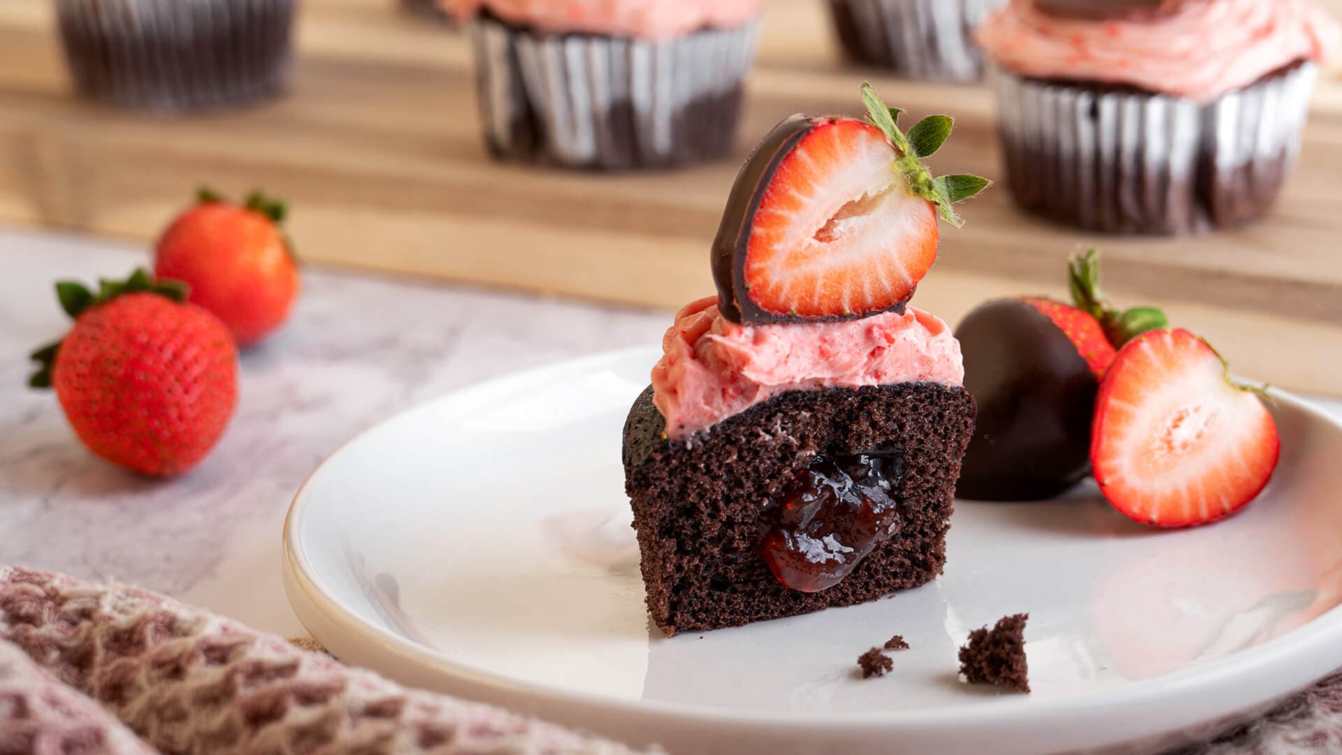 tray of freshly made hersheys chocolate covered strawberry cupcakes