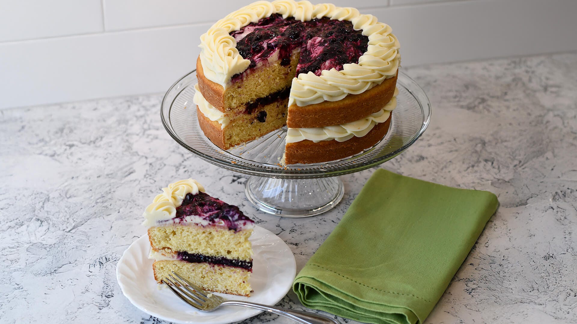 lemon blueberry cake with plated slice