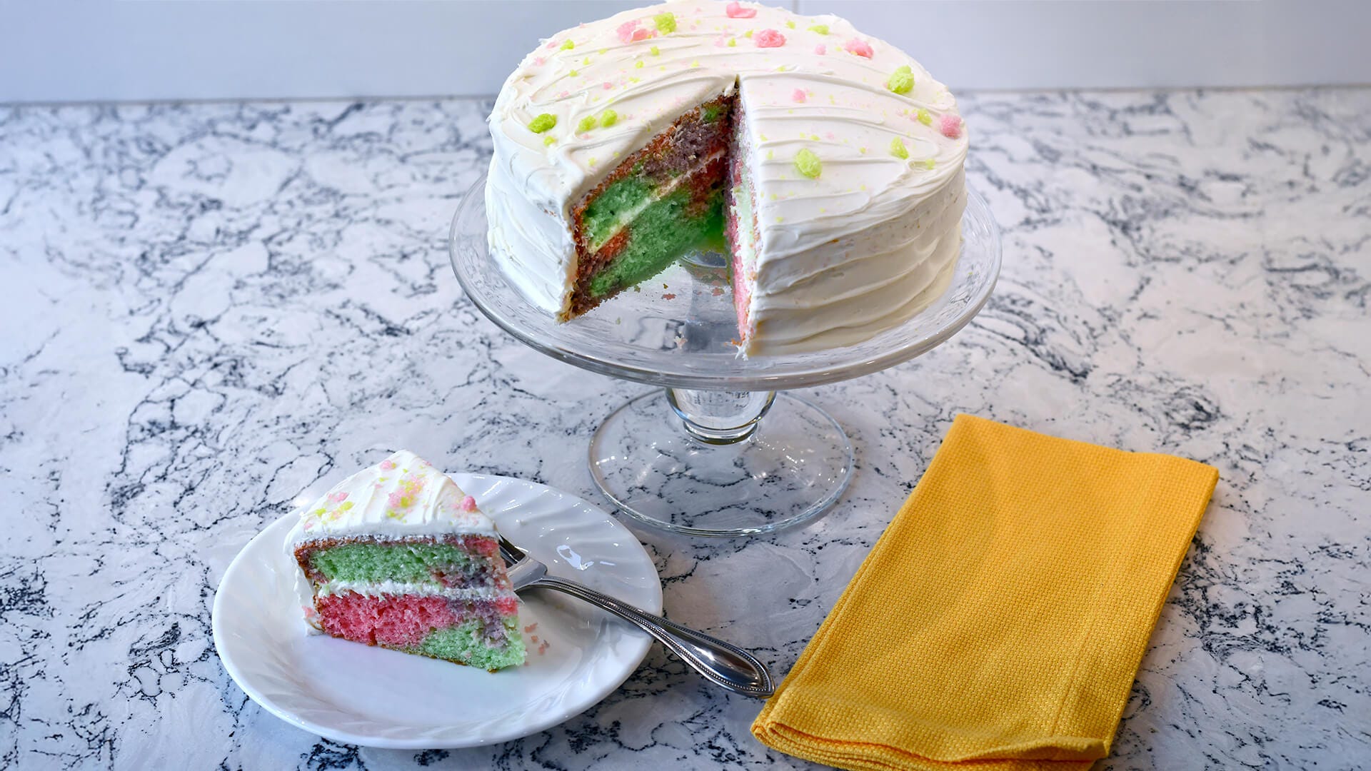 jolly rancher tie dye cake with plated slice