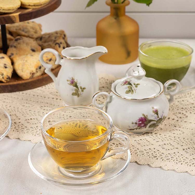 table topped with cups of assorted teas paired with baked goods