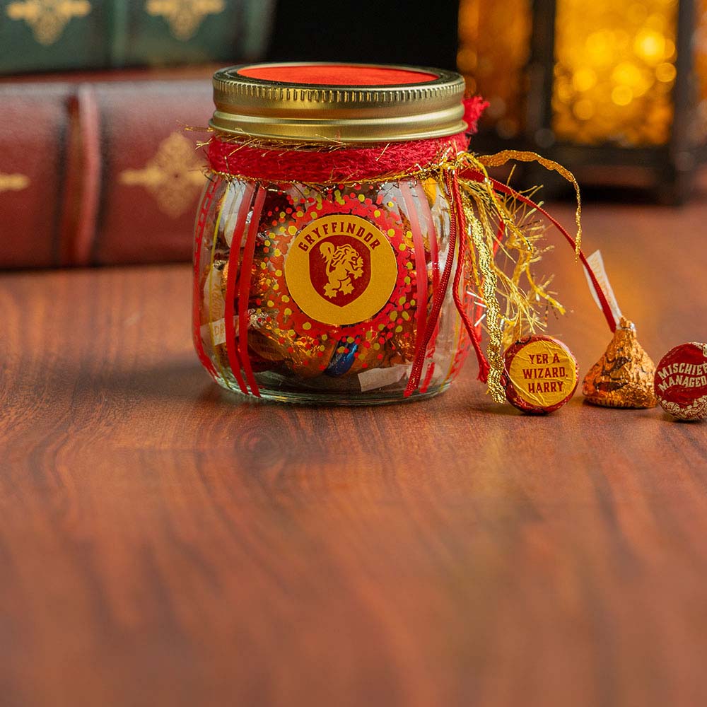 mason jar decorated as the hogwarts gryffindor house filled with hersheys kisses harry potter foils candy